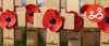 Poppies on small wooden crosses in the grass, to commemorate Remembrance Sunday